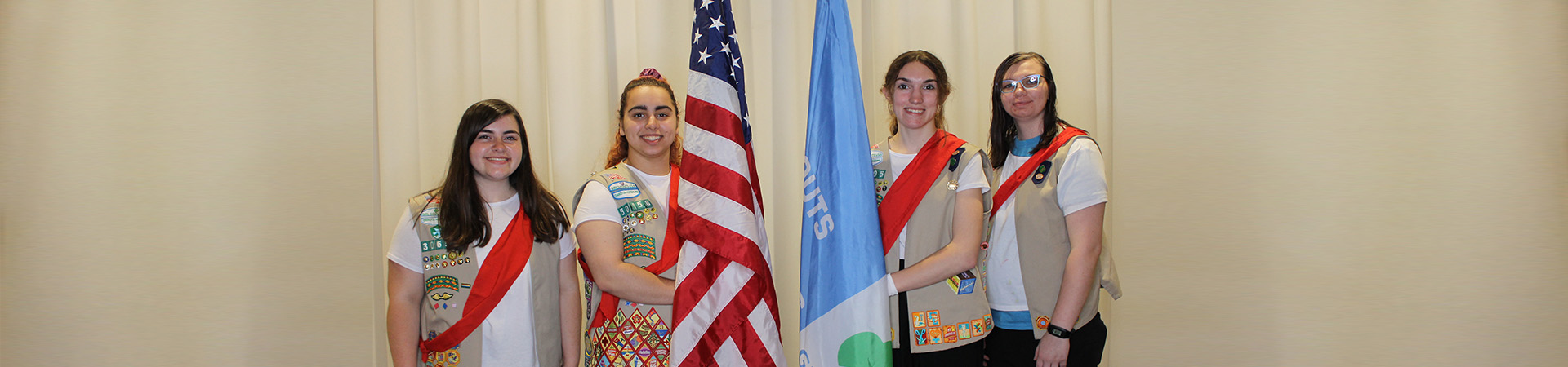  girl scouts preparing for a flag ceremony 