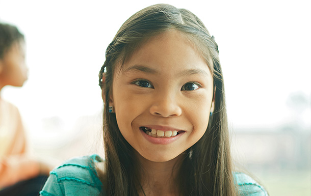 girl with long brown hair smiling