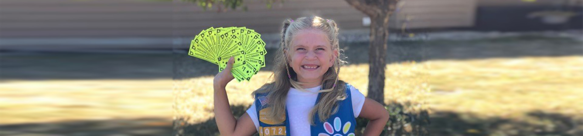  girl scout in uniform holding dakota dough 