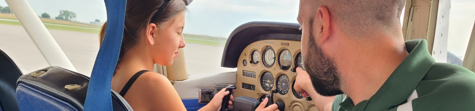 girl scout at controls of an airplane 