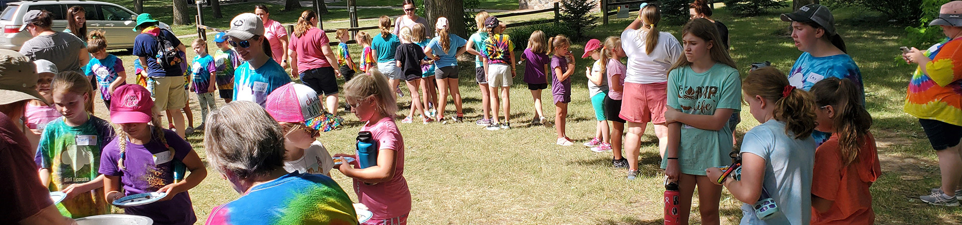  girl scouts at day camp standing in discussion 