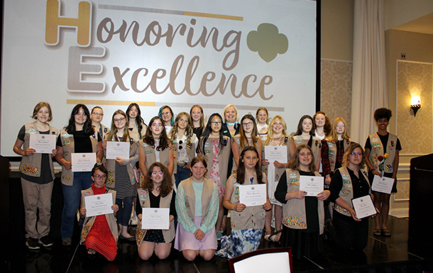 girls scouts receiving awards at honoring excellence